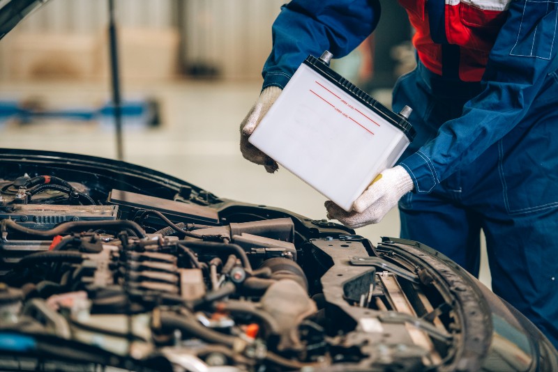 mechanic replacing a car battery