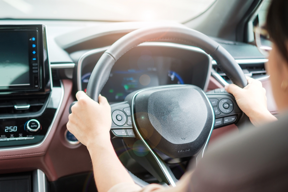 Woman steering a car. Woman steering a car.